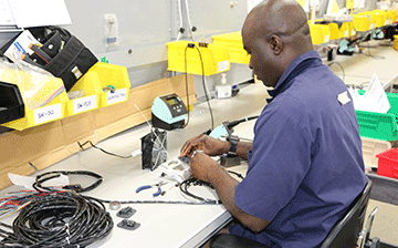Man assembling the faceplate harness Sure Gripcontrols product